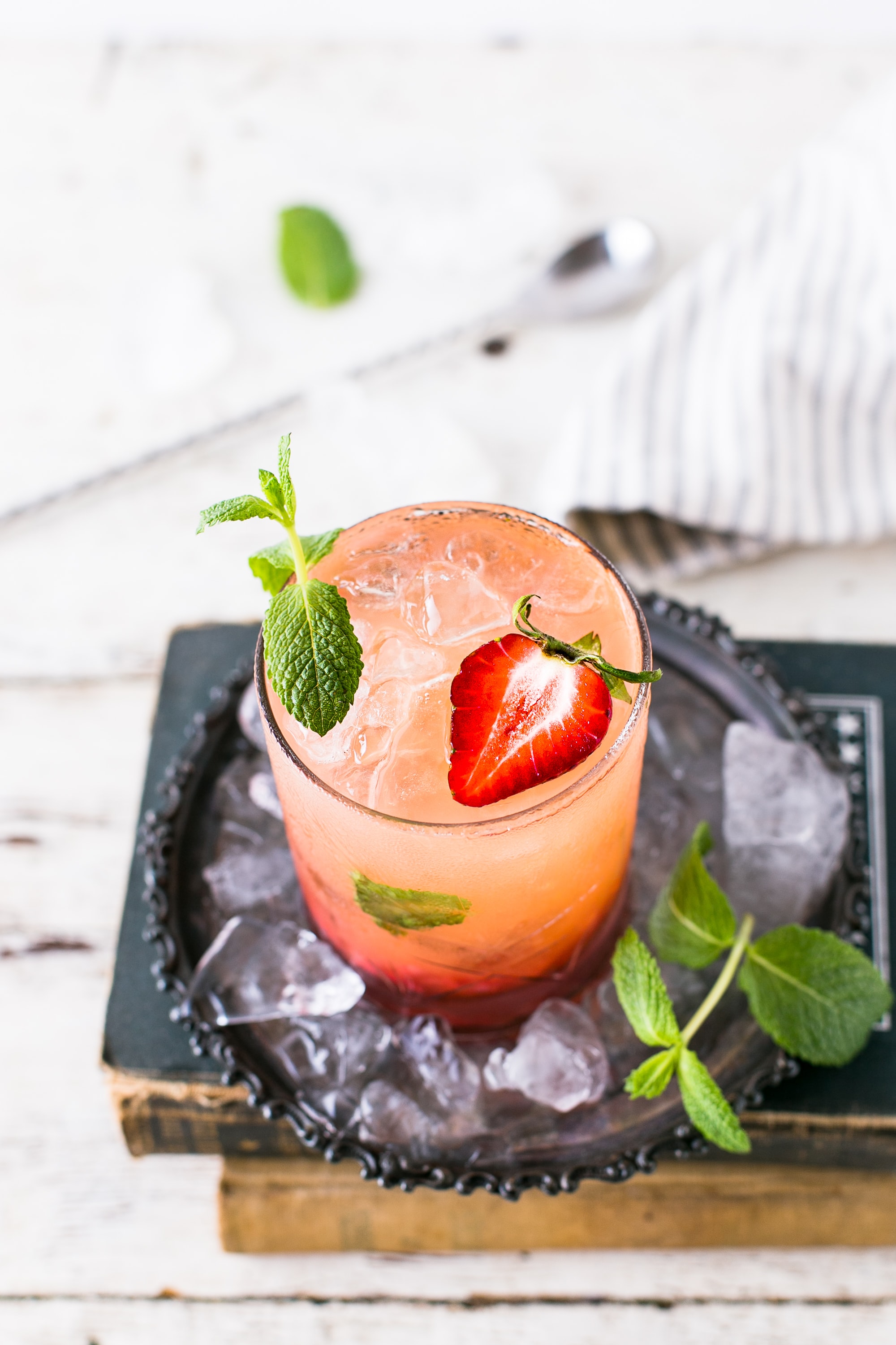 Strawberry Caipiroska. Garnished with strawberries.